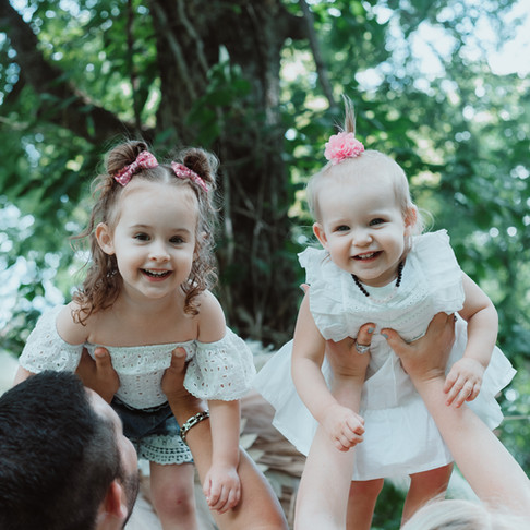Dr. Stephanie Paiva's two young daughters with their father