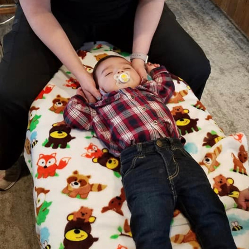 A baby resting comfortably during gentle care